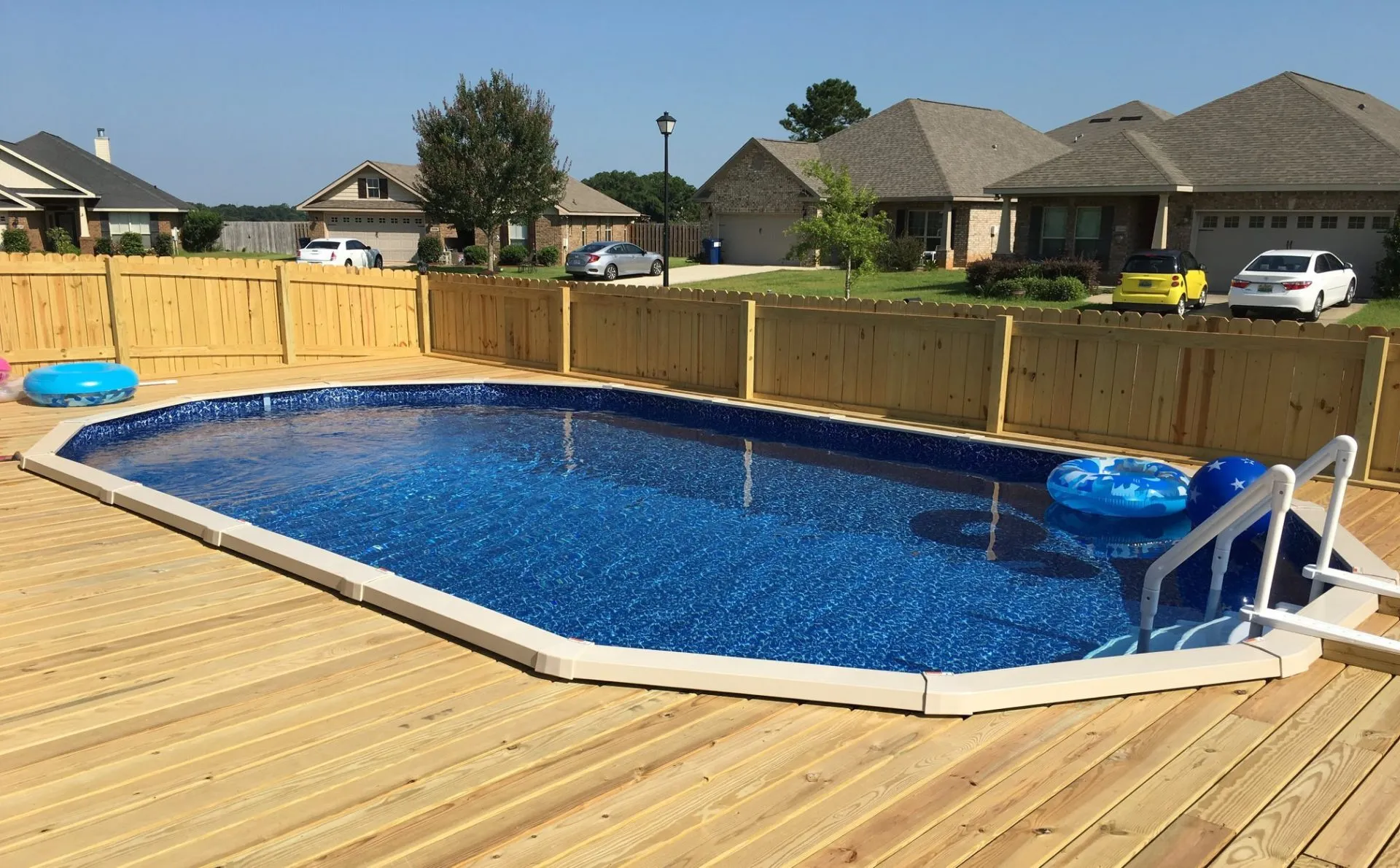 Nicely set up above ground pool w/ awesome wooden deck
